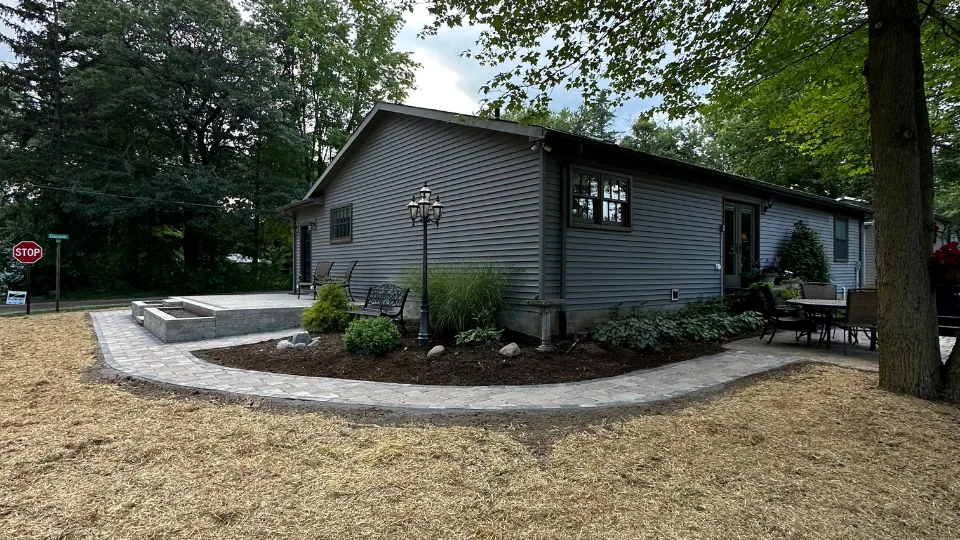 Decorative Flat Stone Retaining Wall, Brick Paver Patio, Stairs and Walkway With Mulched Flower Beds
