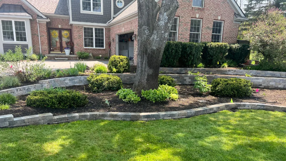 Decorative Flat Stone Retaining Wall With Mulched Flower Beds