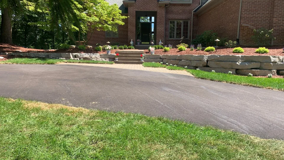 Large Flat Stone Retaining Wall With Flower Beds, Brick Paver Walkway and Stairs