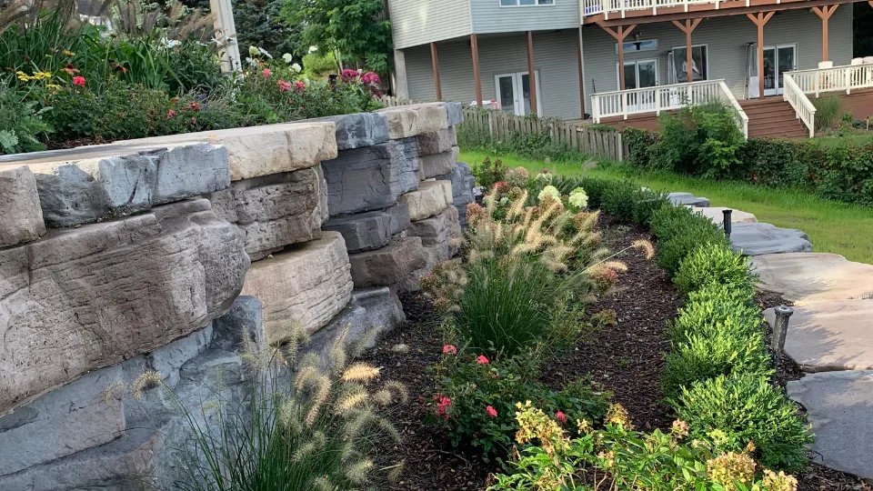 Large Flat Stone Retaining Wall With Multi-Tiered Flower Beds