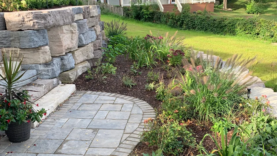 Large Flat Stone Retaining Wall With Multi-Tiered Flower Beds, Brick Pavers and Stairs