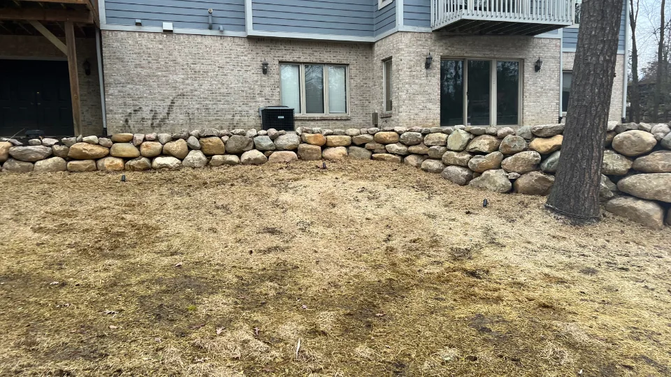 Large Boulder Retaining Wall For Walkout Basement
