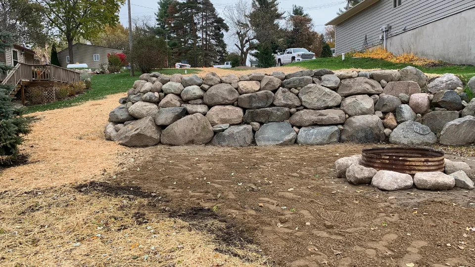 Large Boulder Retaining Wall With Built-In Fire Pit