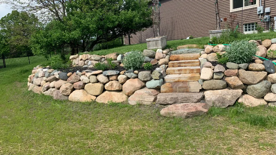Large Boulder Retaining Wall With Built-In Flower Beds